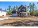 Charming two-story home with gray siding, stone accents, and a well-manicured yard at 6935 Old Jefferson Hwy, Cameron, NC 28326