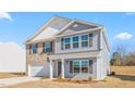 Charming two-story home featuring a mix of brick and siding, and a welcoming front porch at 864 Forth Ct # 150, Gibsonville, NC 27249