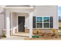 Close up of a well-kept front porch with a black front door at 872 Forth Ct # 149, Gibsonville, NC 27249