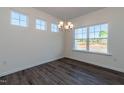 Bright dining room with modern chandelier lighting, lots of natural light, and laminate floors at 88 E Victory View Ter, Smithfield, NC 27577