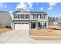 Charming two-story home featuring a classic gray facade, attached two-car garage, and well-maintained front lawn at 1004 Bridgewater Dr, Durham, NC 27704
