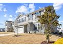 Charming two-story home featuring a classic gray facade, attached two-car garage, and partially landscaped front yard at 1004 Bridgewater Dr, Durham, NC 27704