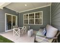 Cozy covered patio with stylish seating area, perfect for outdoor relaxation and entertaining at 1008 Octans Way, Wendell, NC 27591