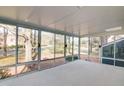 Bright and airy sunroom with walls of windows, offering panoramic views of the serene backyard landscape at 103 Allison Way, Cary, NC 27511