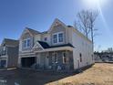 Corner lot two-story home featuring stone accents, a covered porch, and attached garage at 1041 Bostonian Dr, Knightdale, NC 27545
