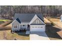 An aerial view of a charming home with a stone facade and an attached two car garage at 110 Lilac Dr, Franklinton, NC 27525