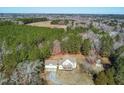 Stunning aerial view of home surrounded by lush green trees with multiple car garage and large yard at 1175 Faulkner Town Rd, Henderson, NC 27537