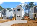 Charming two-story home with a modern design, concrete driveway, and well-manicured front yard at 1215 Chaney Rd, Raleigh, NC 27606