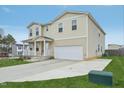 Attractive two-story home with a covered front porch, attached garage and lovely green yard at 128 Glacier Pt, Clayton, NC 27527