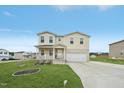 Charming two-story home with a welcoming front porch and a well-manicured lawn and attached garage at 128 Glacier Pt, Clayton, NC 27527