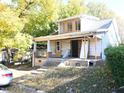 Shows a two-story home with a porch and a new room and windows upstairs at 1404 Gearwood Ave, Durham, NC 27701