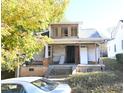 Shows a two-story home with a porch and a new room and windows upstairs at 1404 Gearwood Ave, Durham, NC 27701