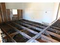 A gutted home with exposed floorboards, insulation, and a window in one of the walls at 1404 Gearwood Ave, Durham, NC 27701