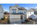 Inviting two-story home with a stone-accented facade, a two-car garage, and well-manicured landscaping at 1516 Ferntree Ct, Morrisville, NC 27560
