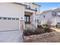 Welcoming two-story home featuring stone accents, a two-car garage, and a beautifully landscaped front yard at 1516 Ferntree Ct, Morrisville, NC 27560