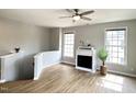 Bright living room with fireplace, ceiling fan, and hardwood floors at 1522 Kudrow Ln, Morrisville, NC 27560