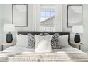 Cozy bedroom with stylish decor, decorative pillows, lamps, and natural light from the window at 2204 Guess Rd, Durham, NC 27705