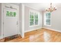Bright entryway with hardwood floors, large windows, and a stylish light fixture at 2209 Woodnell Dr, Raleigh, NC 27603
