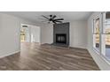 Bright living room featuring luxury vinyl plank flooring and a painted brick fireplace at 2908 Basswood Dr, Raleigh, NC 27610