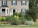 Traditional two-story home featuring a well-manicured front garden and neutral-toned siding at 3320 Derbyshire Pl, Raleigh, NC 27604