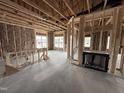 Unfinished living room showcasing the framing, fireplace, and windows that bring in natural light at 40 Tuskeegee Dr, Smithfield, NC 27577