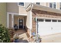 Welcoming front entrance with a charming front porch, stone accents, and an attached garage for convenience at 468 Talons Rest Way, Cary, NC 27513