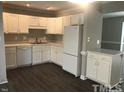Updated kitchen with white cabinets, modern appliances, and ample counter space at 500 Woodcroft Pkwy # 16D, Durham, NC 27713