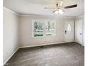 Empty living room showcasing ample natural light with neutral walls and carpet at 5614 Greenbay Dr, Durham, NC 27712