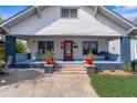 Inviting home showcasing a blue-painted porch, swing, and vibrant landscaping at 709 North St, Durham, NC 27701