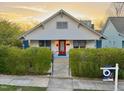 Delightful home with a red door, manicured landscaping, and a 'For Sale' sign at 709 North St, Durham, NC 27701