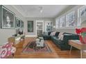Inviting living room with a plush sofa, hardwood floors, and natural light at 709 North St, Durham, NC 27701