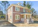 Two-story home with craftsman details, a covered front porch, and beautiful architectural details at 717 Heidelberg St, Durham, NC 27704