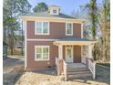 Charming two-story home featuring a welcoming front porch and neutral brown color palette at 717 Heidelberg St, Durham, NC 27704