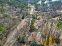 An aerial view of the home nestled amongst trees and a golf course with lake views at 103 Bruce Dr, Cary, NC 27511