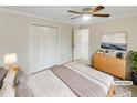 Cozy bedroom with a ceiling fan, closet and a neutral color palette at 11308 Leesville Rd, Raleigh, NC 27613