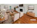 Bright living room featuring a fireplace, wood floors, and modern decor at 11308 Leesville Rd, Raleigh, NC 27613