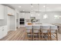 Bright kitchen featuring an oversized island, white cabinets, and stainless appliances at 126 Belmont Stakes Ln, Wendell, NC 27591