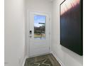 A bright entryway featuring a door with a window and an abstract painting at 1305 White Verona Way, Knightdale, NC 27545