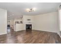 Bright living room with fireplace, hardwood floors, and open access to the kitchen at 155 Jade St, Smithfield, NC 27577