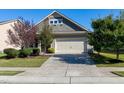 Well-maintained home exterior with a two-car garage, attractive landscaping, and a long, concrete driveway at 1707 Capstone Dr, Durham, NC 27713