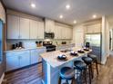Modern kitchen with stainless steel appliances, granite countertops, a kitchen island with seating at 1750 Pie Filling Dr, Haw River, NC 27258