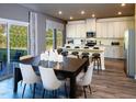 Eat-in kitchen showcasing a dining area and a modern kitchen with stainless steel appliances and island seating at 1750 Pie Filling Dr, Haw River, NC 27258