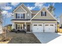 Inviting two-story home with a two-car garage, porch, and landscaped front yard at 192 Kensington Dr, Spring Lake, NC 28390