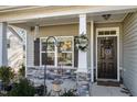 Inviting front porch with stone accents, decorative wreath, and a 'Welcome' sign at 192 Kensington Dr, Spring Lake, NC 28390
