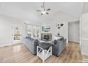 Cozy living room with stone fireplace, ceiling fan, and natural light at 20 Crane Dr, Louisburg, NC 27549