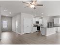 Open-concept living space flowing into the kitchen, showcasing modern finishes and a bright atmosphere at 204 Shelfit Trl, Oxford, NC 27565