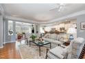 Bright and spacious living room featuring an open floor plan, hardwood floors, and neutral decor at 221 Elverson Pl, Cary, NC 27519