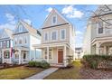 Inviting two-story home with a covered porch, showcasing its neat front yard at 4511 All Points View Way, Raleigh, NC 27614