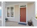 Close-up view of the front porch featuring a wood door and detailed trim at 4511 All Points View Way, Raleigh, NC 27614