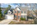 Charming two-story home with a manicured lawn, attached garage, and traditional architectural details at 5302 Silkwood Dr, Durham, NC 27713